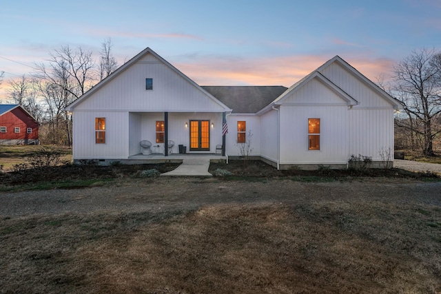 modern inspired farmhouse featuring crawl space, a lawn, a porch, and roof with shingles