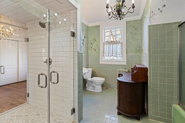 bathroom featuring tile patterned floors, an enclosed shower, tile walls, and an inviting chandelier