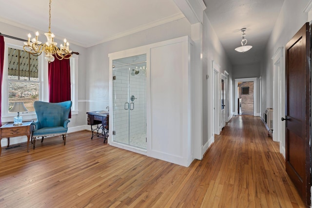 interior space featuring heating unit, crown molding, hardwood / wood-style floors, and an inviting chandelier