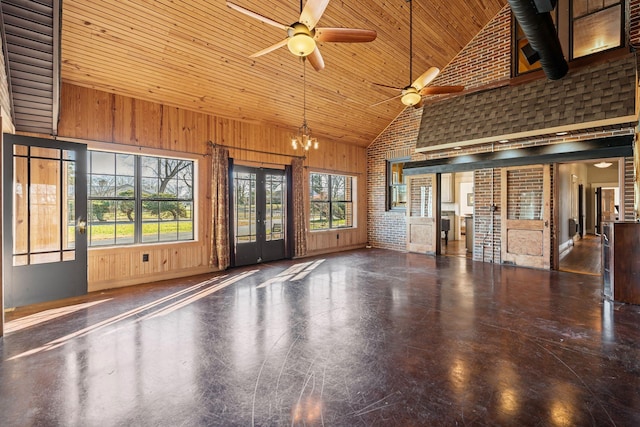 interior space with brick wall, ceiling fan with notable chandelier, wooden walls, high vaulted ceiling, and wooden ceiling