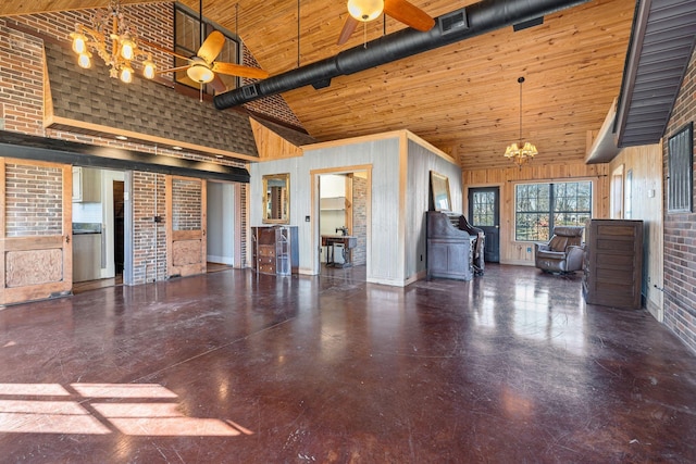 unfurnished living room with high vaulted ceiling, wooden walls, a notable chandelier, wood ceiling, and brick wall