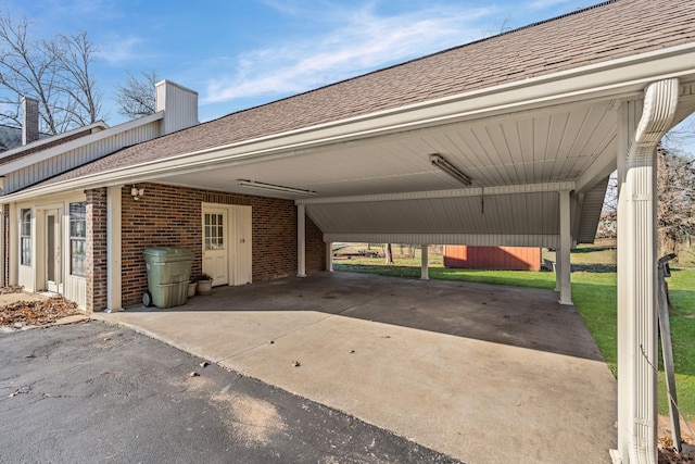 exterior space with a lawn and a carport