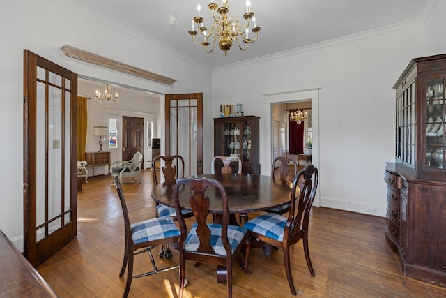 dining area with french doors, dark wood-type flooring, an inviting chandelier, and ornamental molding