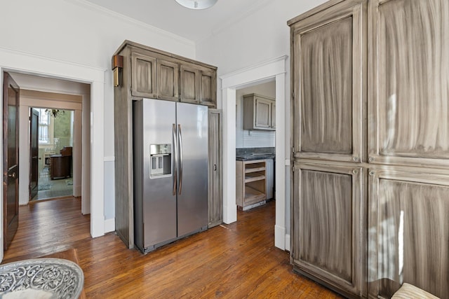 kitchen featuring stainless steel refrigerator with ice dispenser, dark hardwood / wood-style floors, and crown molding