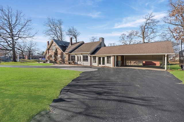 view of front of house with a front lawn and a carport