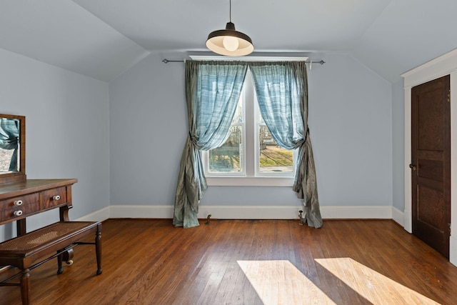 interior space with hardwood / wood-style floors and vaulted ceiling