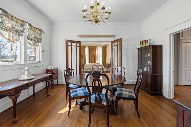 dining space featuring dark hardwood / wood-style floors, french doors, crown molding, and an inviting chandelier