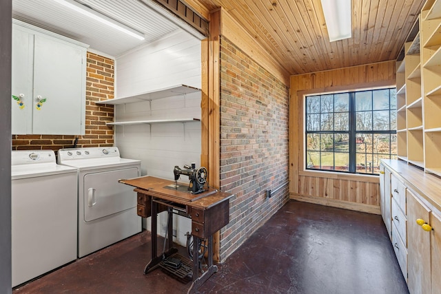 clothes washing area with brick wall, washing machine and dryer, wooden walls, and wood ceiling