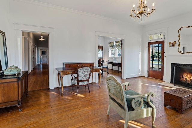 living room with a chandelier, wood-type flooring, and ornamental molding