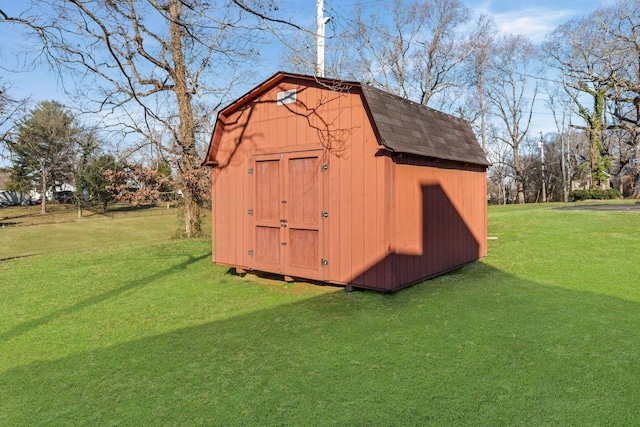 view of outbuilding featuring a yard