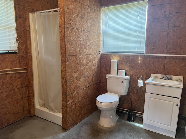 bathroom featuring a shower with shower curtain, vanity, tile walls, concrete floors, and toilet