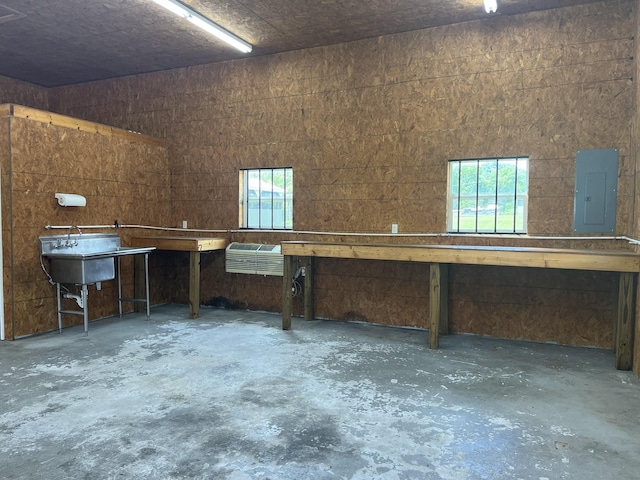 misc room featuring electric panel and a wall mounted AC