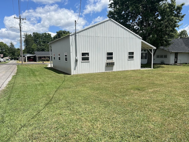 view of outdoor structure featuring a yard and a carport