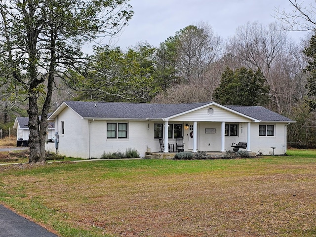 ranch-style home with a porch and a front yard