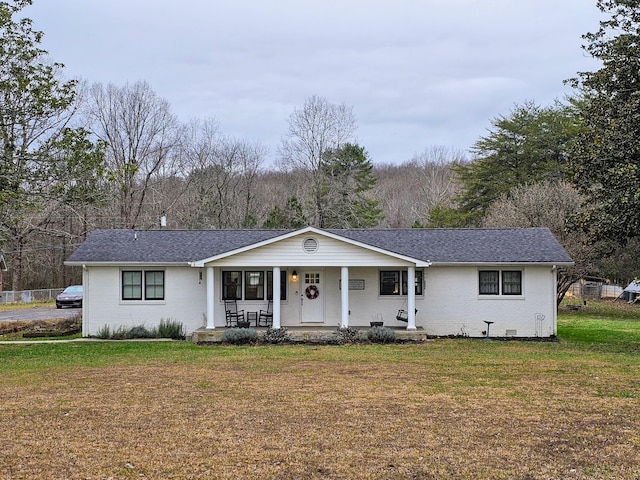 ranch-style home featuring a front yard and a porch