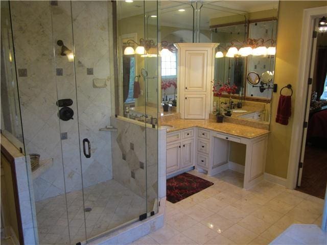 bathroom featuring vanity and a shower with shower door