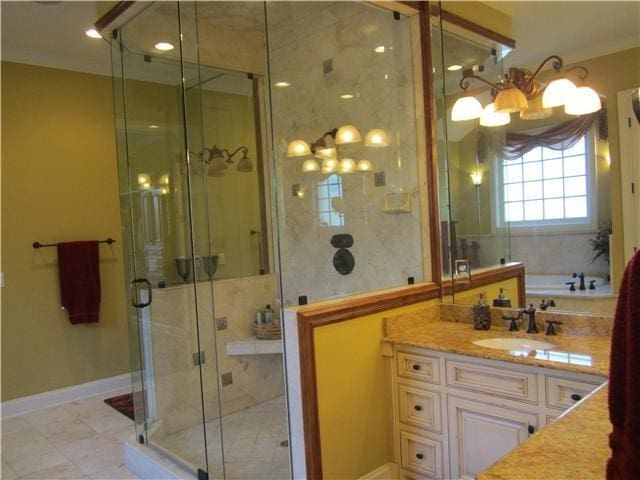 bathroom featuring plus walk in shower and vanity