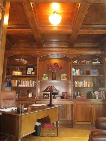 home office with wood walls, light wood-type flooring, wood ceiling, and built in features