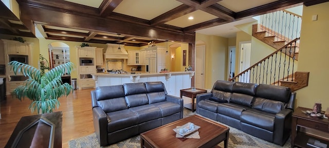 living room featuring beam ceiling, light hardwood / wood-style flooring, and coffered ceiling