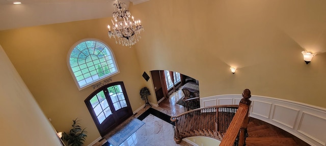 interior space with french doors and a chandelier