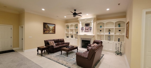 living room with built in shelves, ceiling fan, light tile patterned floors, and crown molding