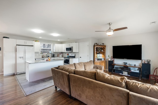 living room with hardwood / wood-style floors and ceiling fan