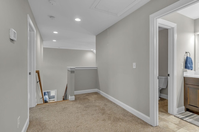 hall with light colored carpet