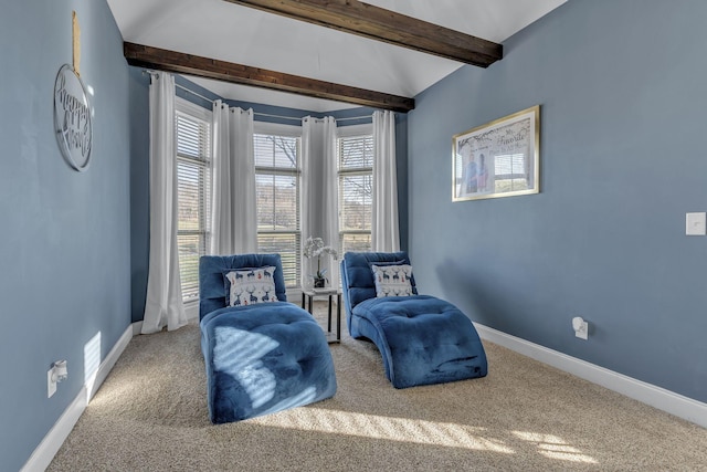 living area with beamed ceiling and carpet flooring