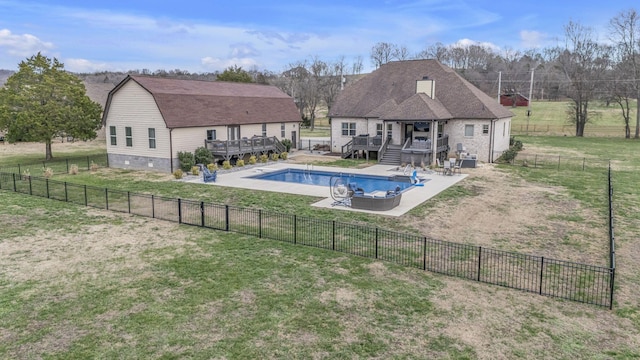 view of swimming pool featuring a lawn and a wooden deck