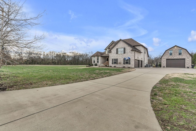 view of front of home featuring a front yard and a garage