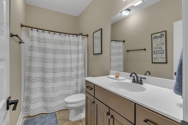 bathroom featuring tile patterned flooring, vanity, toilet, and walk in shower