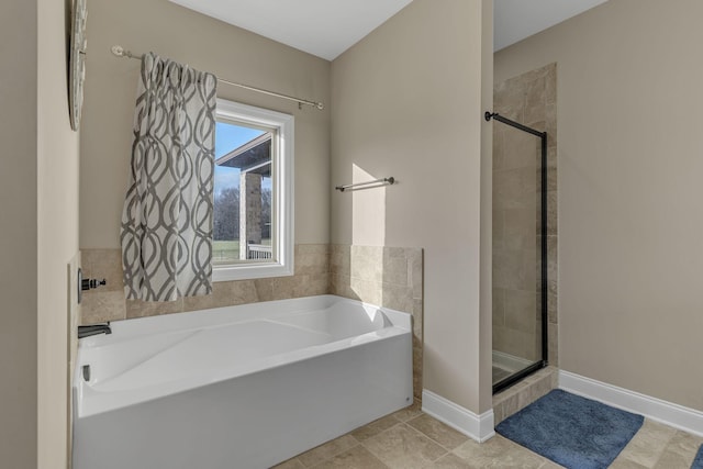 bathroom with tile patterned floors and independent shower and bath