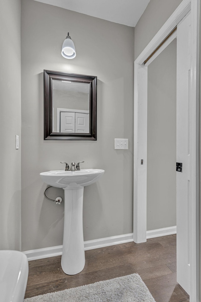 bathroom with hardwood / wood-style floors