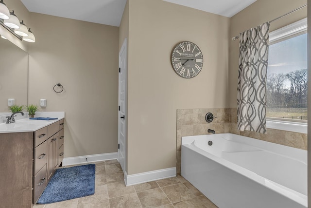 bathroom featuring a washtub and vanity