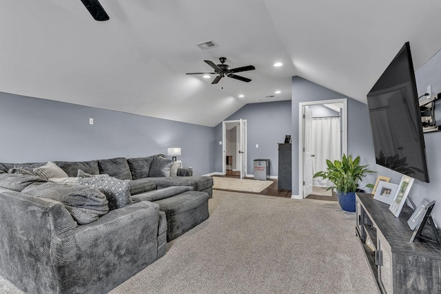 living room featuring ceiling fan, carpet, and vaulted ceiling