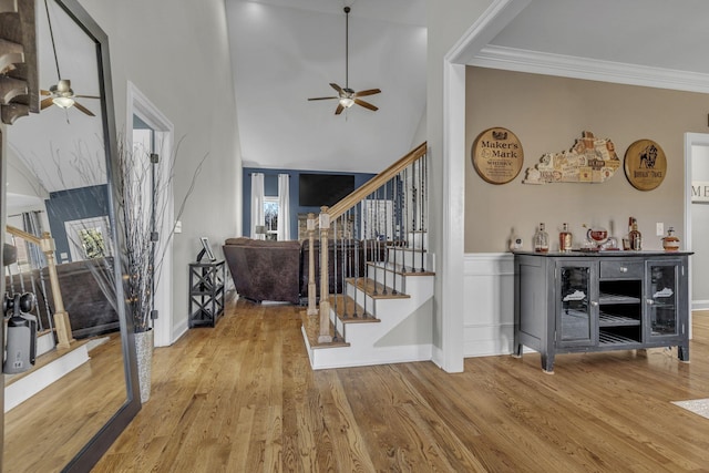 foyer with hardwood / wood-style flooring, ceiling fan, and ornamental molding