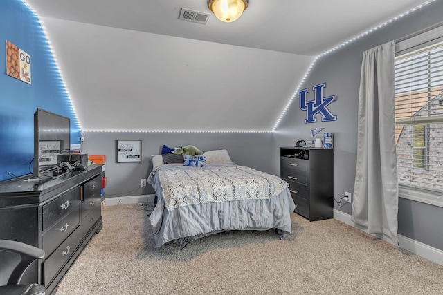 carpeted bedroom with multiple windows and vaulted ceiling