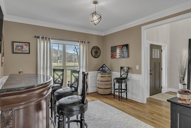 office with light wood-type flooring and crown molding