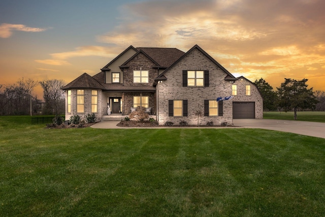 view of front of house with a yard and a garage