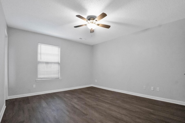 spare room featuring ceiling fan, dark hardwood / wood-style flooring, and a textured ceiling