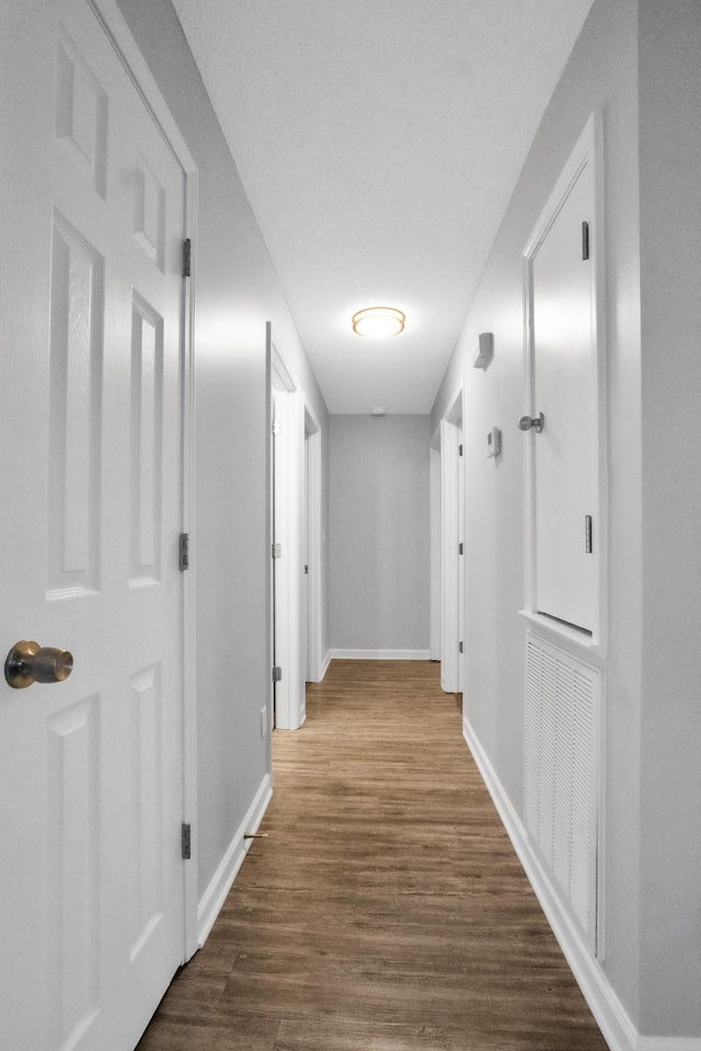 hallway with dark hardwood / wood-style floors