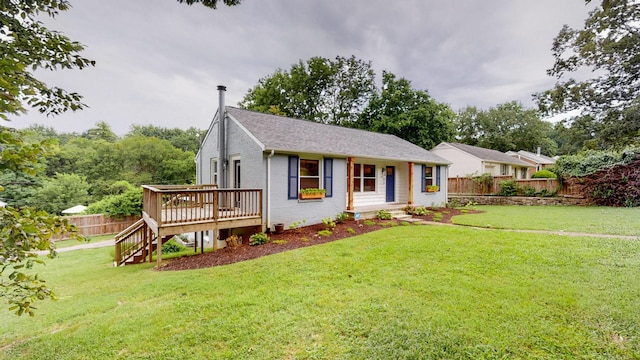 ranch-style home featuring a wooden deck and a front lawn