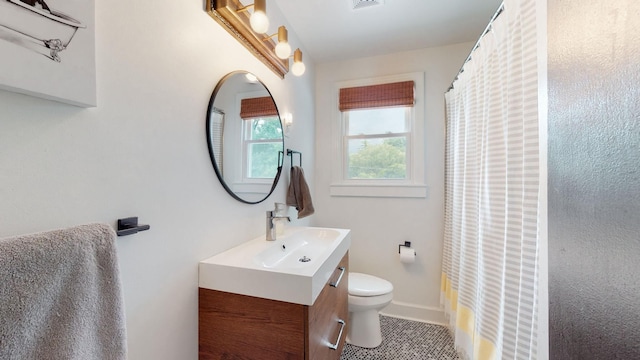 bathroom featuring tile patterned floors, vanity, a shower with shower curtain, and toilet