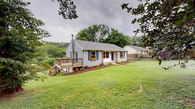 view of front facade with a front lawn and a deck