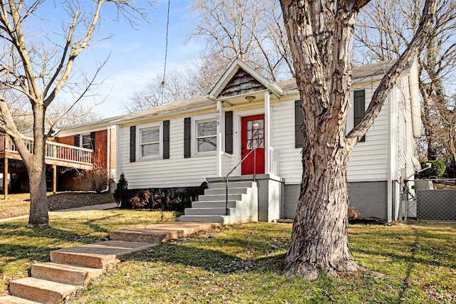 view of front of house with cooling unit and a front lawn