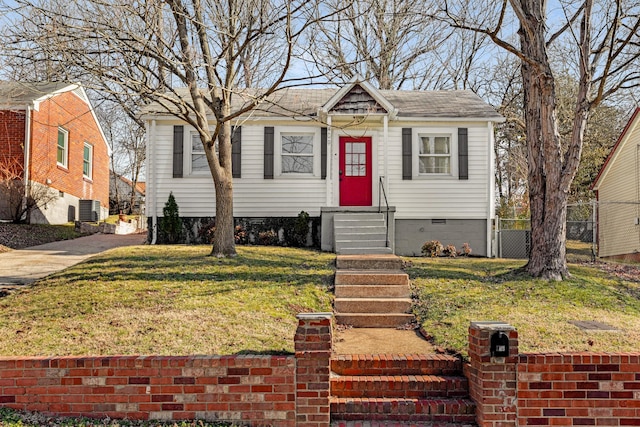 bungalow-style home with a front yard and cooling unit