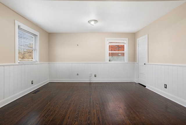 spare room with dark hardwood / wood-style floors