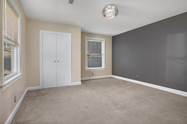 unfurnished bedroom with carpet and a closet