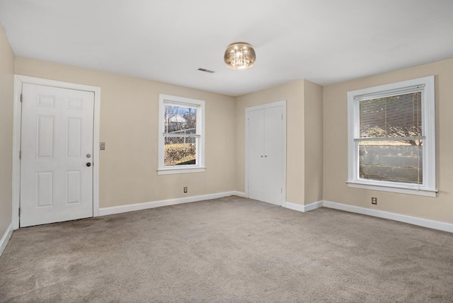 spare room with light colored carpet