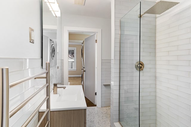 bathroom featuring tile patterned floors, vanity, and tiled shower